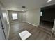 Spacious living room with wood-look floors and neutral colors is ready for personal touches at 5216 Davisson Ave, Orlando, FL 32810