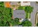 Aerial view of a house with a well-maintained roof and mature trees surrounding the property at 530 Hiawatha Palm Pl, Apopka, FL 32712