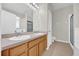 Bathroom featuring a double sink vanity, tile floors, and a shower with glass door at 530 Hiawatha Palm Pl, Apopka, FL 32712