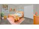 Stylized bedroom featuring a bed, closet, a side table, and a window with a view at 530 Hiawatha Palm Pl, Apopka, FL 32712