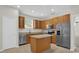 Well-equipped kitchen with stainless steel appliances and light wood cabinets at 530 Hiawatha Palm Pl, Apopka, FL 32712