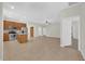 Expansive open-concept living space with tile flooring, adjacent to a modern kitchen at 530 Hiawatha Palm Pl, Apopka, FL 32712