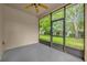 Sunroom featuring a screened in door and wall to wall windows with backyard views at 530 Hiawatha Palm Pl, Apopka, FL 32712