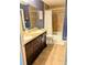 Bathroom featuring a double vanity with granite countertop, and a tiled shower/tub combo at 600 Lake St, Fruitland Park, FL 34731