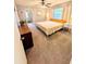 A bright bedroom with a wood bed frame, white walls, and natural light from the windows at 600 Lake St, Fruitland Park, FL 34731