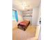 Small bedroom with carpet, a single bed, window, and built-in shelving at 600 Lake St, Fruitland Park, FL 34731