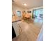 Open-concept dining area with wood floors, seating, and access to multiple rooms at 600 Lake St, Fruitland Park, FL 34731