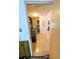 A tiled laundry room with a washer, dryer, shelving, and ample storage space at 600 Lake St, Fruitland Park, FL 34731