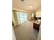 Spacious living room with plush gray carpet, natural lighting, and sliding glass doors to the pool at 600 Lake St, Fruitland Park, FL 34731