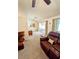 Comfortable living room with a sliding door, plush carpet and leather sofas at 600 Lake St, Fruitland Park, FL 34731