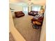 Spacious living room with plush carpeting, multiple sofas, and large windows at 600 Lake St, Fruitland Park, FL 34731