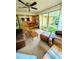 Bright living room with large windows and views to the dining area, adorned with a ceiling fan at 600 Lake St, Fruitland Park, FL 34731
