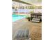 Relaxing poolside featuring a spa, covered patio, and comfortable furniture. A perfect outdoor retreat at 600 Lake St, Fruitland Park, FL 34731