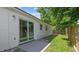 The backyard features a concrete patio, partial fencing, and mature landscaping at 6148 Landrace Ln, Orlando, FL 32807