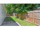 The backyard includes a well-maintained fence and green lawn at 6148 Landrace Ln, Orlando, FL 32807