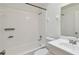 Bathroom view featuring a tub/shower combination, tile, and white fixtures at 6148 Landrace Ln, Orlando, FL 32807
