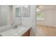 Well-lit bathroom featuring a sink with light countertop, modern fixtures and shower at 6148 Landrace Ln, Orlando, FL 32807