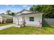 Charming single-story home with an attached garage, front porch, and landscaping at 6148 Landrace Ln, Orlando, FL 32807