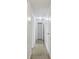 Hallway featuring neutral tile floors with a view of the linen closet at 6148 Landrace Ln, Orlando, FL 32807