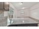 Modern kitchen view with granite countertop overlooking the living room at 6148 Landrace Ln, Orlando, FL 32807