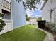 Backyard featuring a well-maintained lawn, stone pathway, and privacy fence at 616 Nadina Pl, Celebration, FL 34747