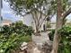 Outdoor patio with stone walkway, lush landscaping, and mature trees at 616 Nadina Pl, Celebration, FL 34747