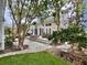 Exterior view of backyard with stone patio, string lights, and manicured landscaping at 616 Nadina Pl, Celebration, FL 34747