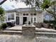 Exterior view of a stone patio with wicker furniture, and a barbeque at 616 Nadina Pl, Celebration, FL 34747