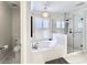 Bright bathroom featuring a soaking tub, stand-alone shower, and white cabinetry with tile flooring at 616 Nadina Pl, Celebration, FL 34747