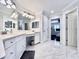Bright bathroom with double vanity and tile floors leads to bedroom at 616 Nadina Pl, Celebration, FL 34747