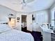 Bedroom featuring dark wood floors, ceiling fan, and built-in desk at 616 Nadina Pl, Celebration, FL 34747