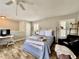 Bright bedroom featuring hardwood floors, a cozy chair, and a comfortable bed at 616 Nadina Pl, Celebration, FL 34747