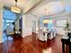 Spacious dining room with hardwood floors, a decorative hutch, and an open transition to the staircase at 616 Nadina Pl, Celebration, FL 34747