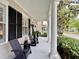 Inviting front porch with comfortable seating and classic white columns, great for relaxing outdoors at 616 Nadina Pl, Celebration, FL 34747
