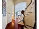 Hallway with hardwood floors leads to a staircase and living area with a vaulted ceiling at 616 Nadina Pl, Celebration, FL 34747
