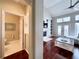 Hallway view to half bath and living room showcasing a fireplace, vaulted ceiling, and staircase at 616 Nadina Pl, Celebration, FL 34747