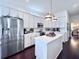 Bright kitchen showcasing white cabinetry, stainless steel appliances, and a marble-topped island at 616 Nadina Pl, Celebration, FL 34747