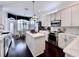Bright kitchen with stainless steel appliances, a marble island, white cabinetry, and hardwood floors at 616 Nadina Pl, Celebration, FL 34747