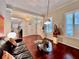 Inviting living room with rich hardwood floors, comfortable seating, and an open layout to the dining area at 616 Nadina Pl, Celebration, FL 34747