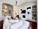 Spacious living room featuring hardwood flooring, fireplace, white sofa, and vaulted ceilings at 616 Nadina Pl, Celebration, FL 34747