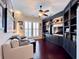 Comfortable living room with hardwood flooring, custom built-in shelving, and a ceiling fan at 616 Nadina Pl, Celebration, FL 34747