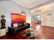 Stylish living room with hardwood floors, ample lighting, and an open view to the dining room, perfect for gatherings at 616 Nadina Pl, Celebration, FL 34747