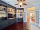 Living room featuring built-in shelves with decor and French doors to the dining room at 616 Nadina Pl, Celebration, FL 34747