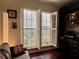 Cozy living room featuring hardwood floors, a ceiling fan, and large windows with shutters at 616 Nadina Pl, Celebration, FL 34747
