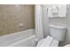 Bathroom featuring a tiled shower/tub combo, toilet, and white towels at 6402 Parc Corniche Dr # 5304, Orlando, FL 32821