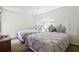 Bedroom with two beds, gray comforters, and decorative pillows; furniture in view at 6402 Parc Corniche Dr # 5304, Orlando, FL 32821