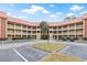 Beautiful building complex with a terra cotta tile roof, white railings, and manicured landscaping at 6402 Parc Corniche Dr # 5304, Orlando, FL 32821