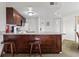 Functional kitchenette featuring granite countertops, wooden cabinets, and bar stool seating at 6402 Parc Corniche Dr # 5304, Orlando, FL 32821