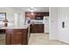 Functional kitchenette featuring granite countertops, wooden cabinets, and modern appliances at 6402 Parc Corniche Dr # 5304, Orlando, FL 32821