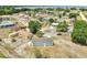 Aerial view of a home in a community near a lake, showcasing the surrounding neighborhood at 7 Garvey Ln, Frostproof, FL 33843